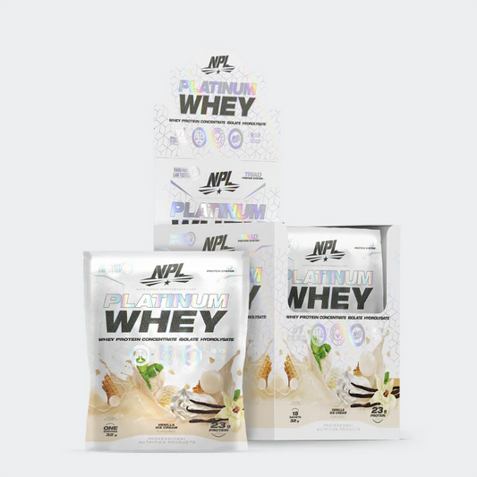 A stack of NPL Platinum Whey protein supplement sachets in vanilla flavor.